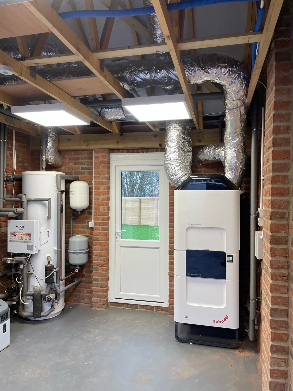 Garage plant room with hot water cylinder, Zehnder MVHR unit and insulated ducting