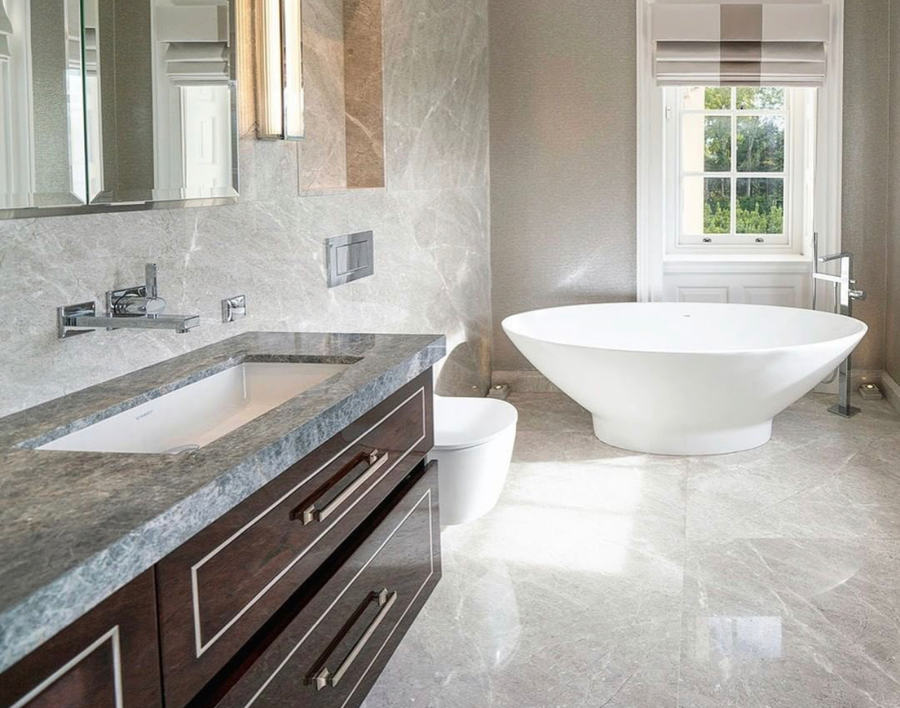 Classic bathroom with stone vanity, wall-hung WC and freestanding bath