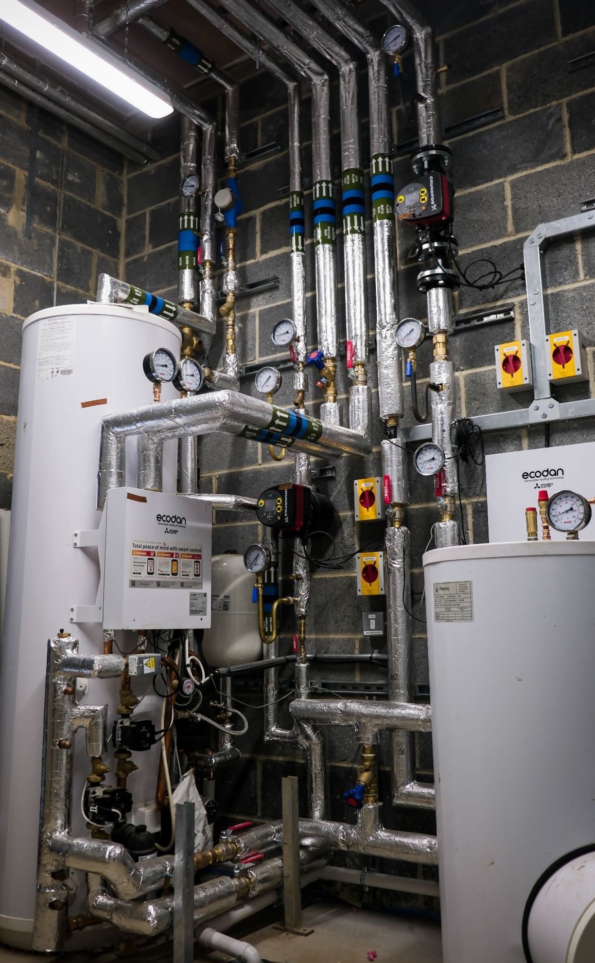 Mitsubishi Electric Ecodan plant-room installation with insulated hydraulic distribution.