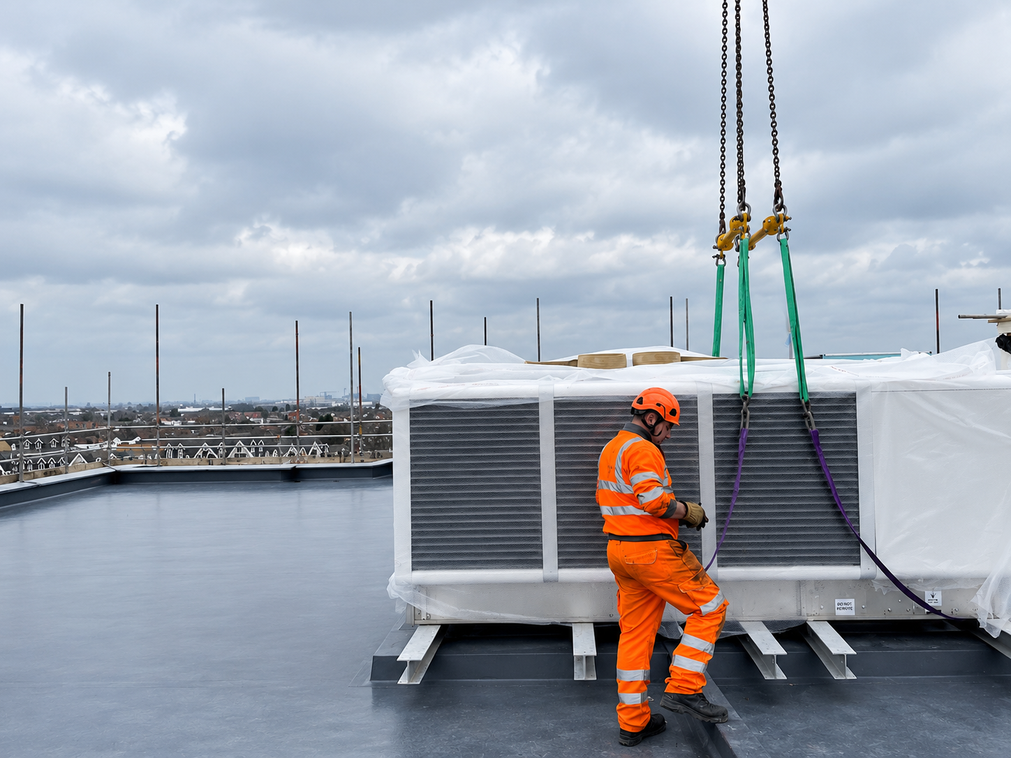 Rooftop air source heat pump plant during final positioning.