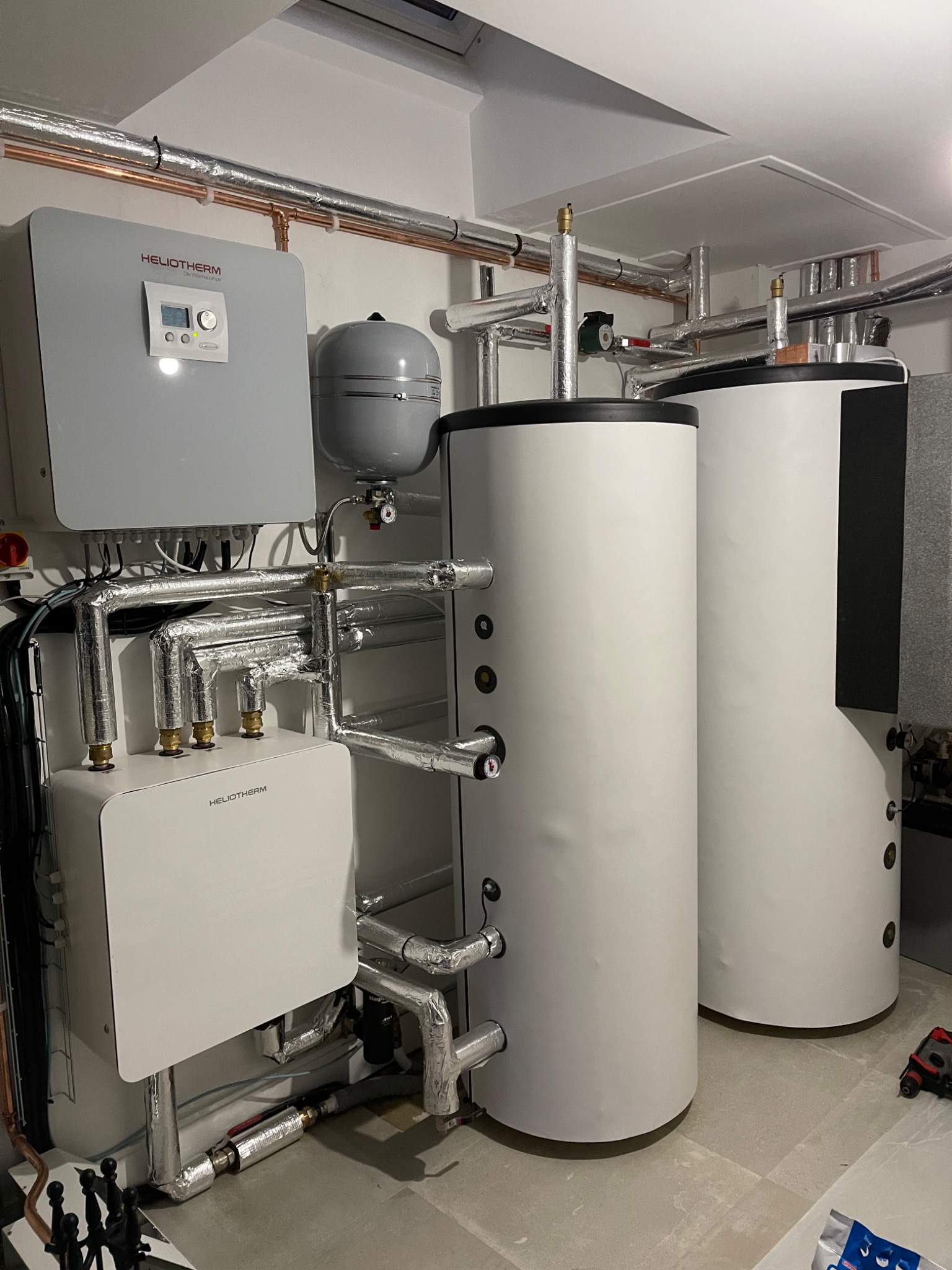 Heliotherm heat pump with two large cylinders and insulated pipework