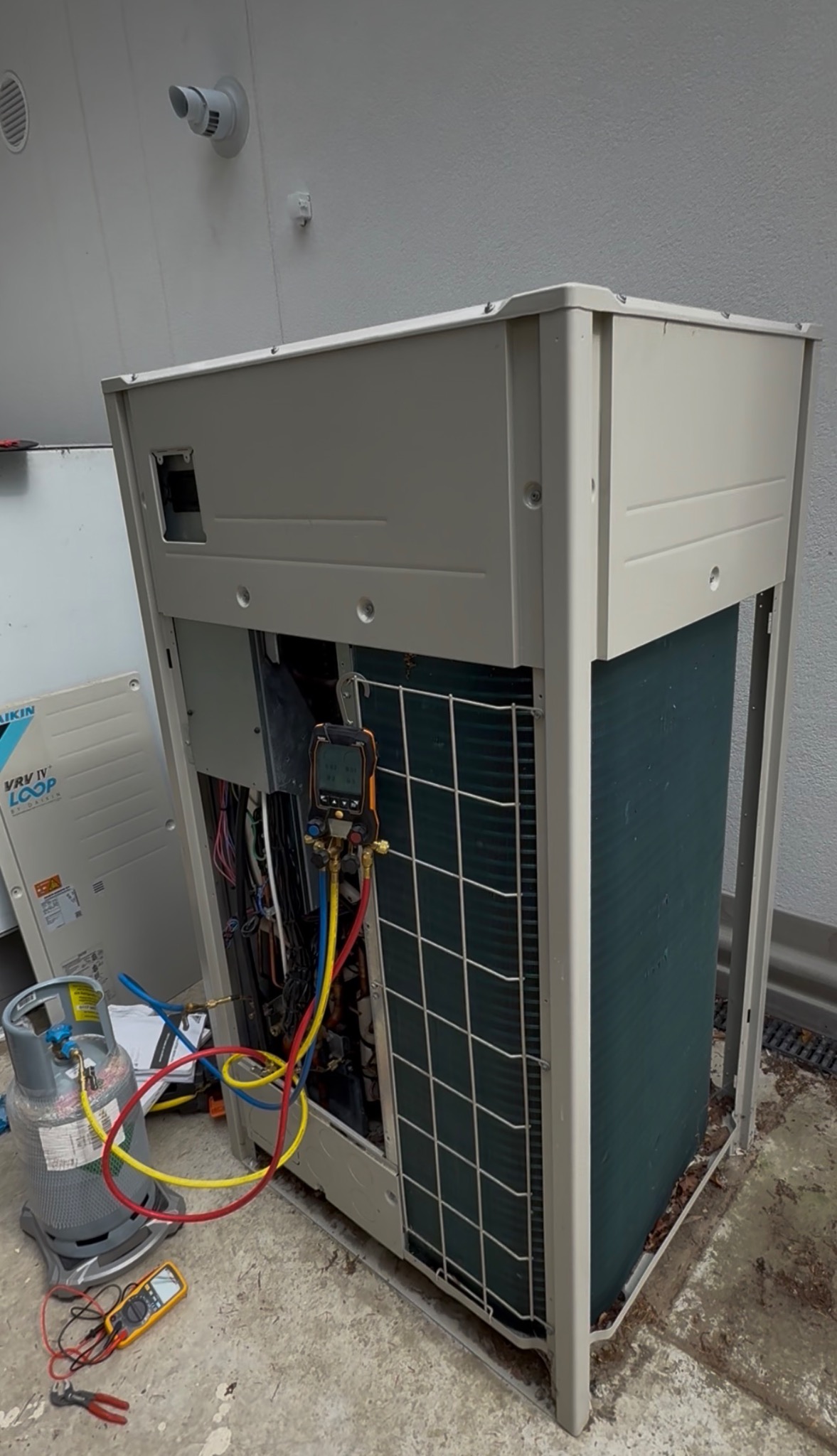 Daikin VRV outdoor unit during commissioning and refrigerant service work.