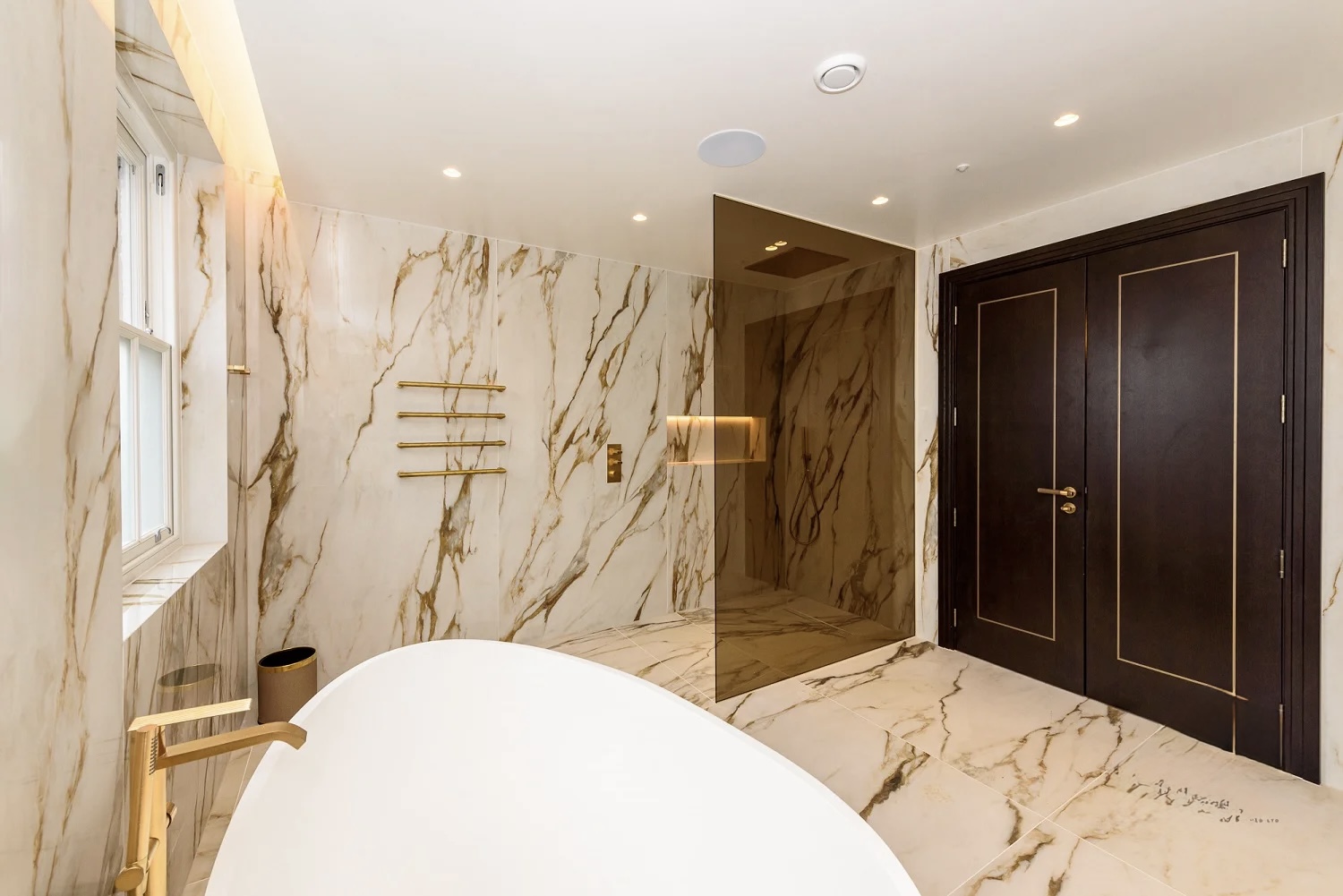 Freestanding bath and walk-in shower, Calacatta stone finish