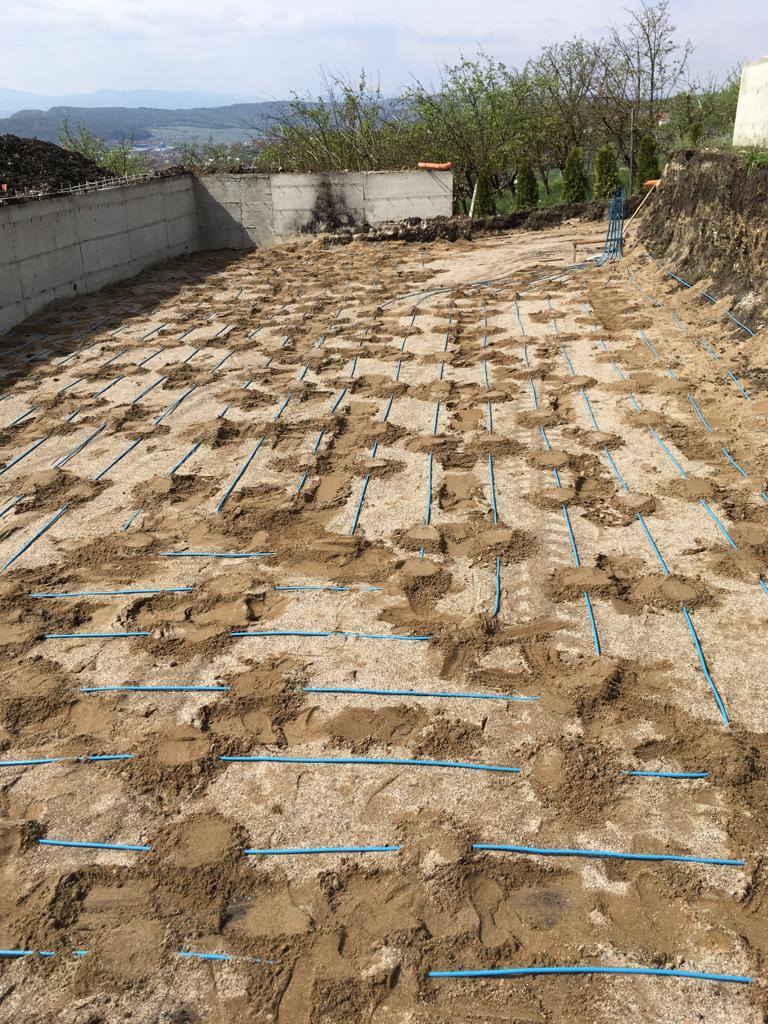 Horizontal collector pipework laid across a prepared ground bed