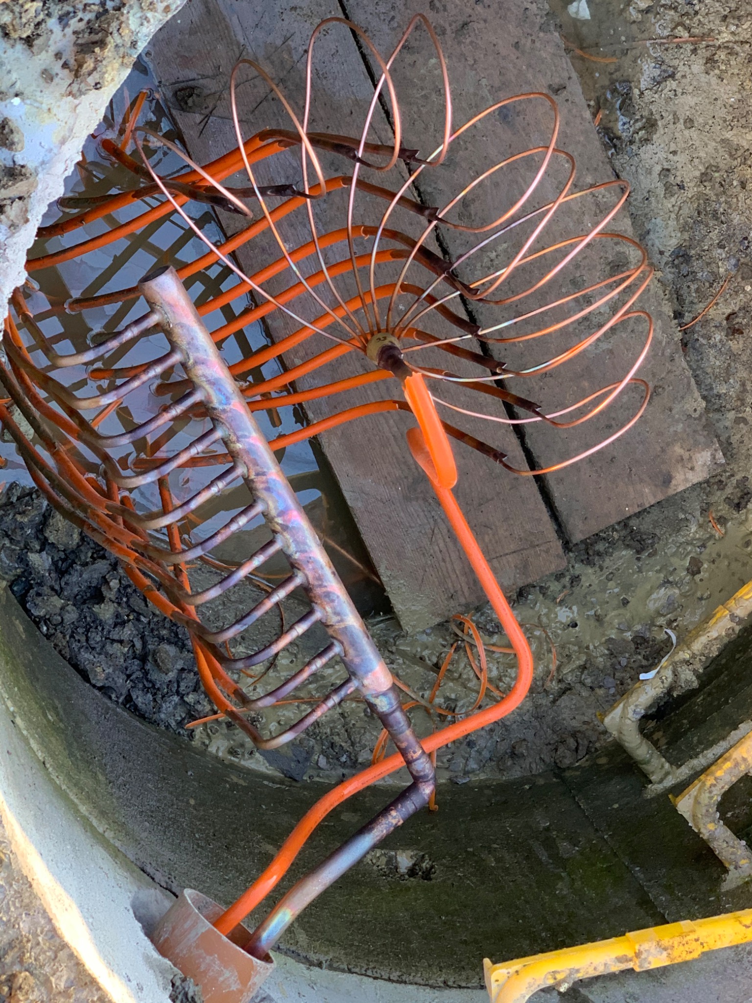 Detailed ground collector header connections inside a chamber
