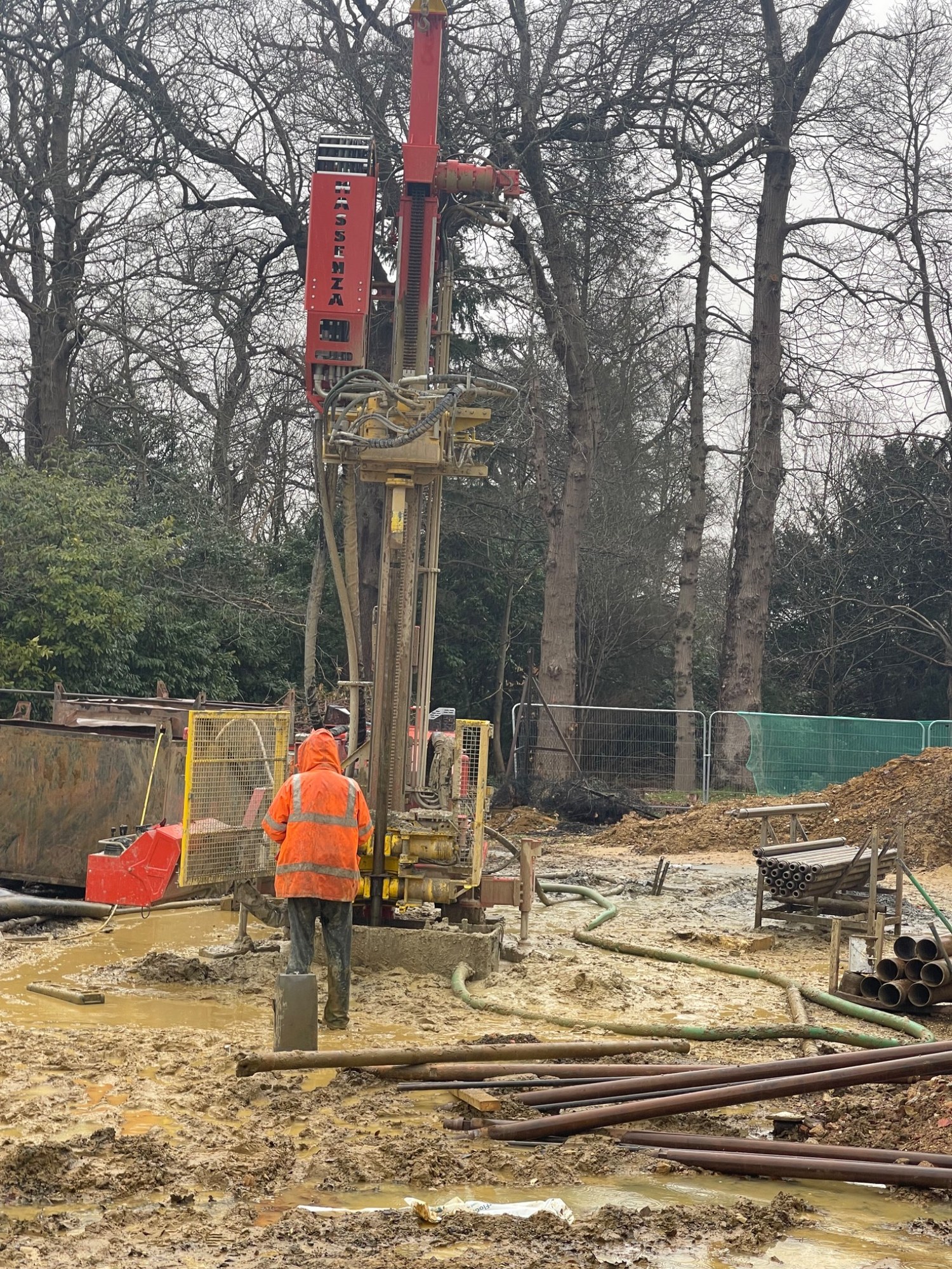 Vertical borehole drilling operation with rig and drill rods