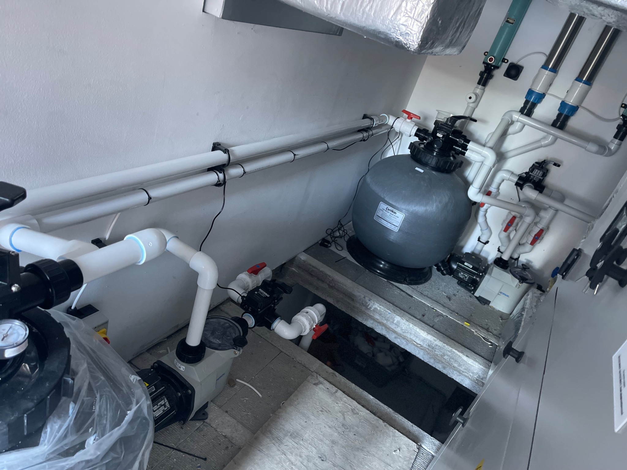 Solux swimming pool plant room installation — filtration set with valved pipework and pumps