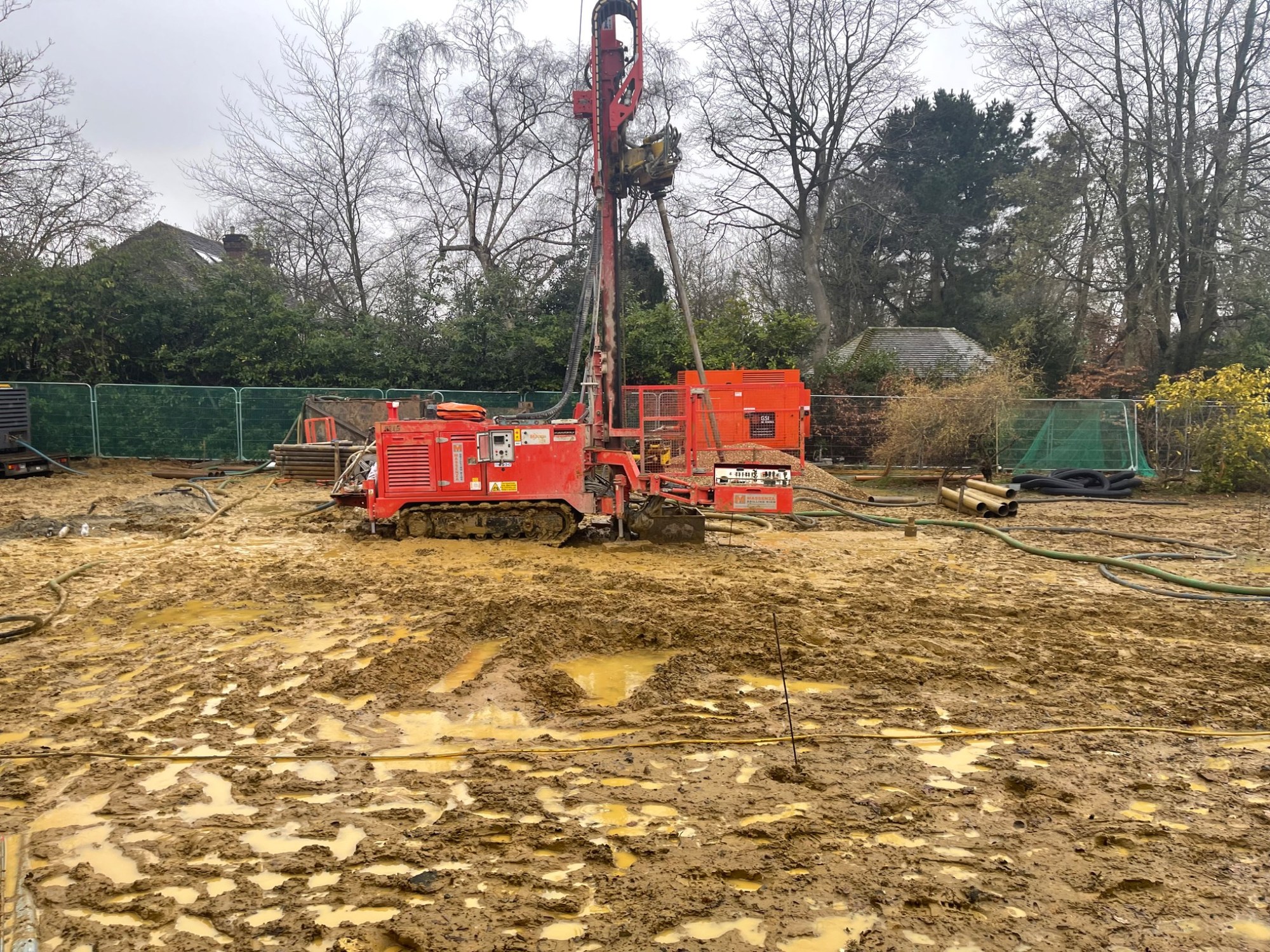Vertical borehole drilling rig operating across a prepared site