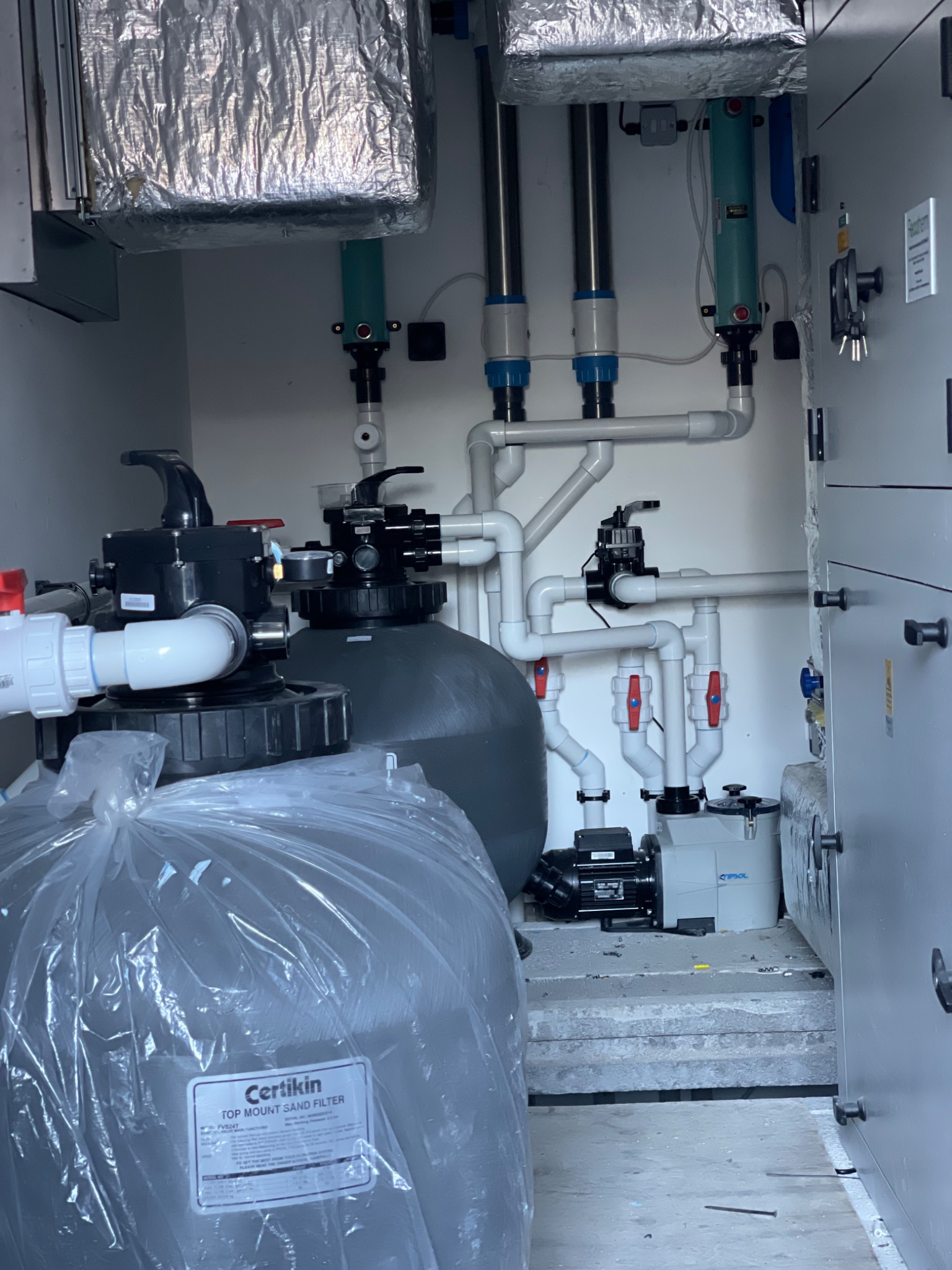 Solux swimming pool plant room installation — sand filters, multiport valves and pump sets