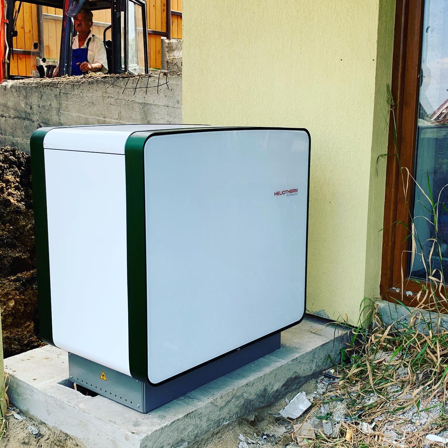 Heliotherm heat pump unit installed on a prepared external plinth.