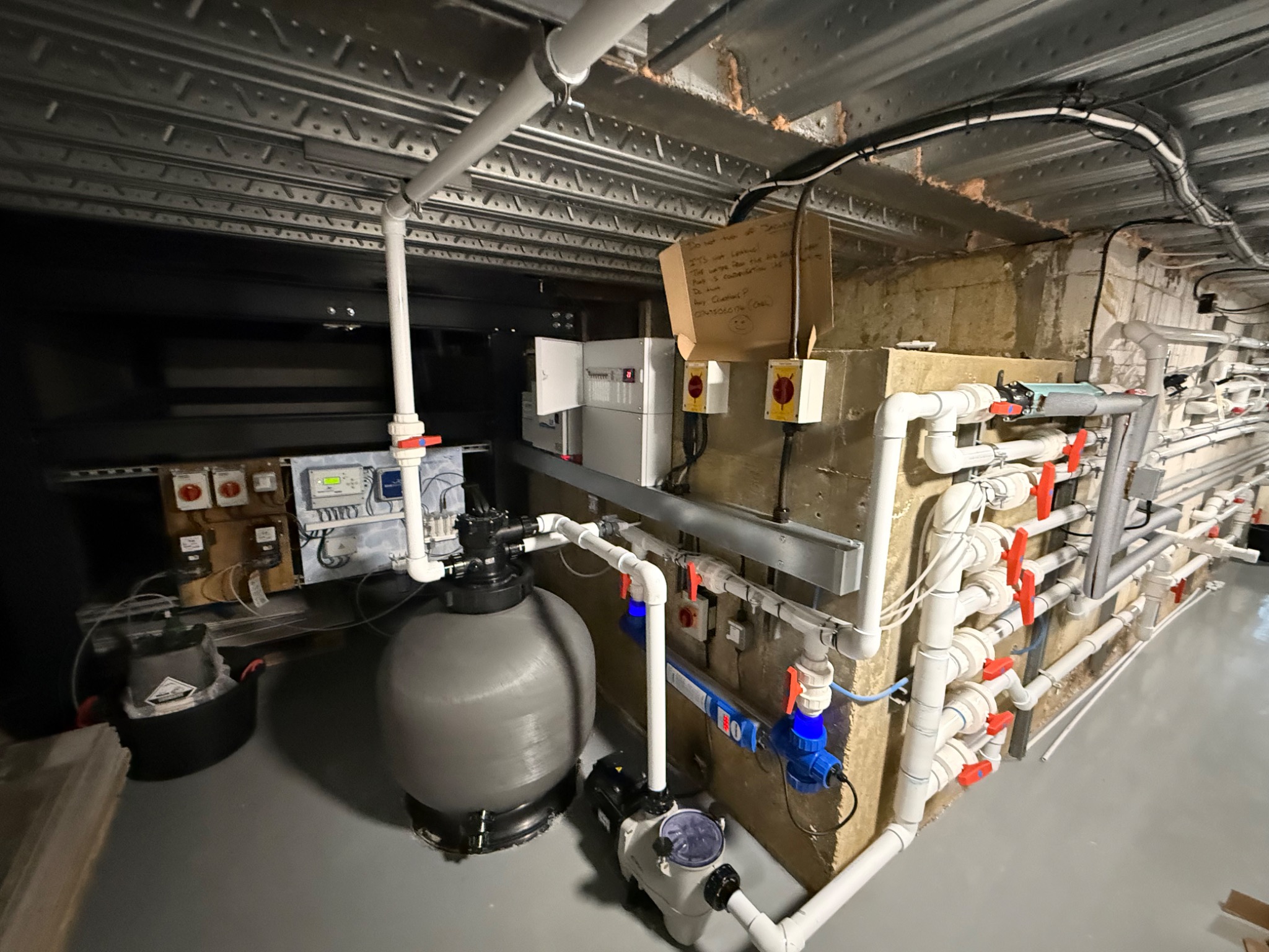 Solux swimming pool plant room installation — sand filter, circulation pump and dosing control station